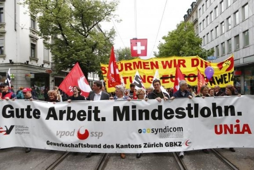 Protesters walk in downtown Zurich during a May Day demonstration May 1, 2014.
