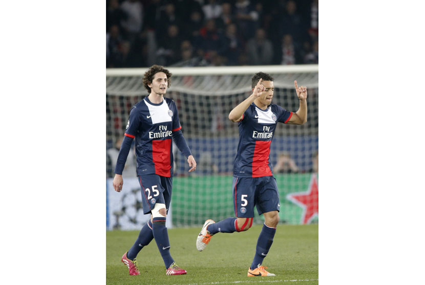 PSG's Marquinhos, right, celebrates his goal with PSG's Adrien Rabiot during the Champions League round of 16 second leg soccer match between Paris Saint Germain and Bayer Leverkusen at the Parc des Princes stadium in Paris, Wednesday, March 12, 2014