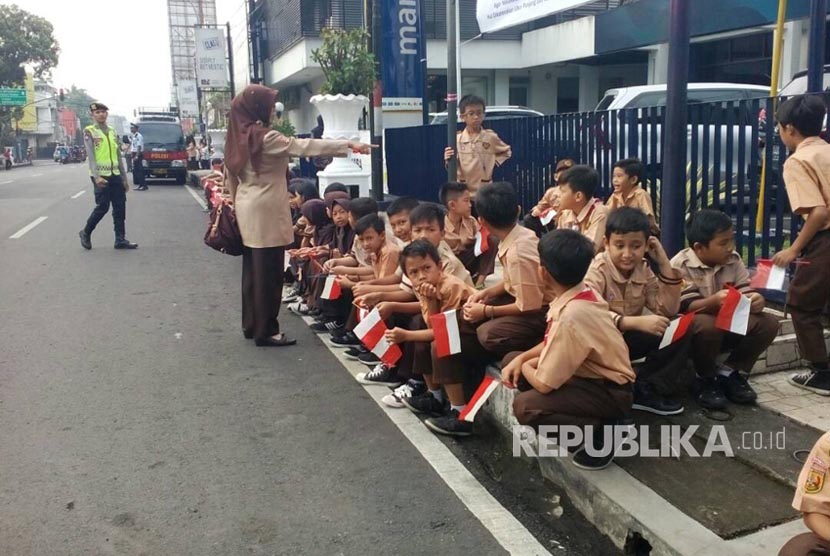 Puluhan murid SDN Citapen menunggu kedatangan Presiden Joko Widodo di jalan Otto Iskandar Dinata, Jumat (9/6) pagi.