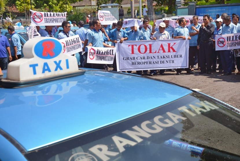 Puluhan sopir taksi melakukan unjuk rasa di kantor Dishubkominfo Provinsi NTB di Mataram, Rabu (23/3).