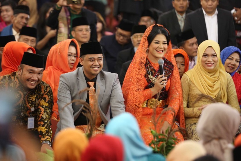 Putri Presiden Joko Widodo, Kahiyang Ayu (kedua kanan) bersama suaminya Bobby Afif Nasution mengikuti ritual adat Mangalo-alo Mora pada ngunduh mantu resepsi pernikahannya di Medan, Sumatera Utara, Jumat (24/11). 