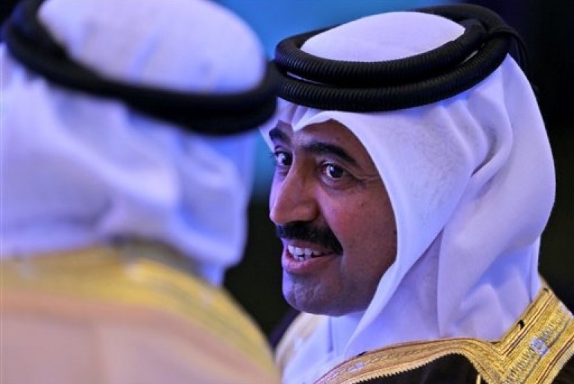 Qatar's Mohammed Bin Saleh Al-Sada, Minister of Energy and Industry speaks with his Saudi counterpart during the opening day of the 10th Arab energy Conference in Abu Dhabi, United Arab Emirates, Sunday, Dec. 21, 2014. 