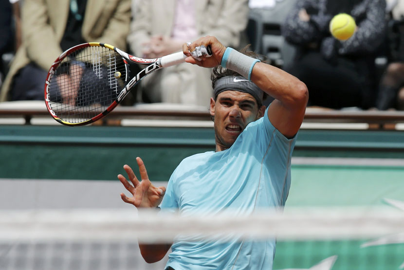 Rafael Nadal, petenis asal Spanyol, melepaskan forehand saat menghadapi petenis Austria, Dominic Thiem, dalam pertandingan Prancis Terbuka di Roland Garros, Paris, Kamis (29/5). 