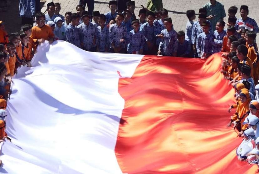 Ratusan murid SD Muhammadiyah Plus Kota Salatiga membentangkan bendera Merah Putih raksasa, di halaman sekolah mereka, Kamis (16/8). Bendera berukuran 25 x 5 meter ini sebelumnya dijahit oleh 150 murid SD Muhammadiyah Plus ini. 