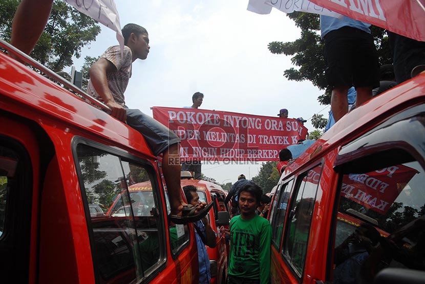 Ratusan sopir angkutan kota Koperasi Wahana kalpika (KWK) jurusan Muara Karang-Pantai Indah kapuk dan Bus Kopami B 02 jursusan Senen-Muara Karang saat melakukan demonstrasi di depan gedung Balai Kota, Jakarta Pusat, Selasa (11/2).