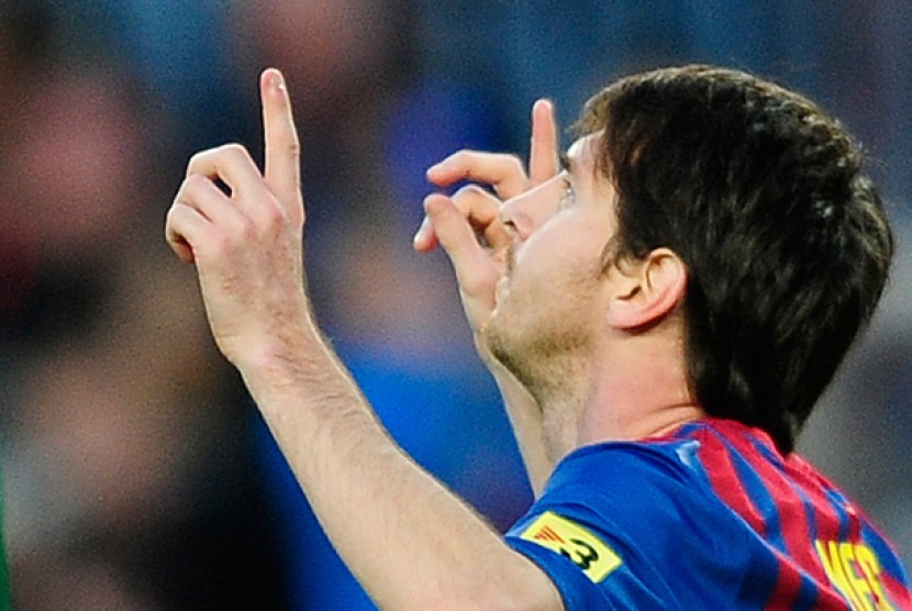 Reaksi Lionel Messi, kanan, Setelah mencetak gol melawan Malaga, Kamis (5/3) dinihari WIB. Timnya, Barcelona unggul 4-1.