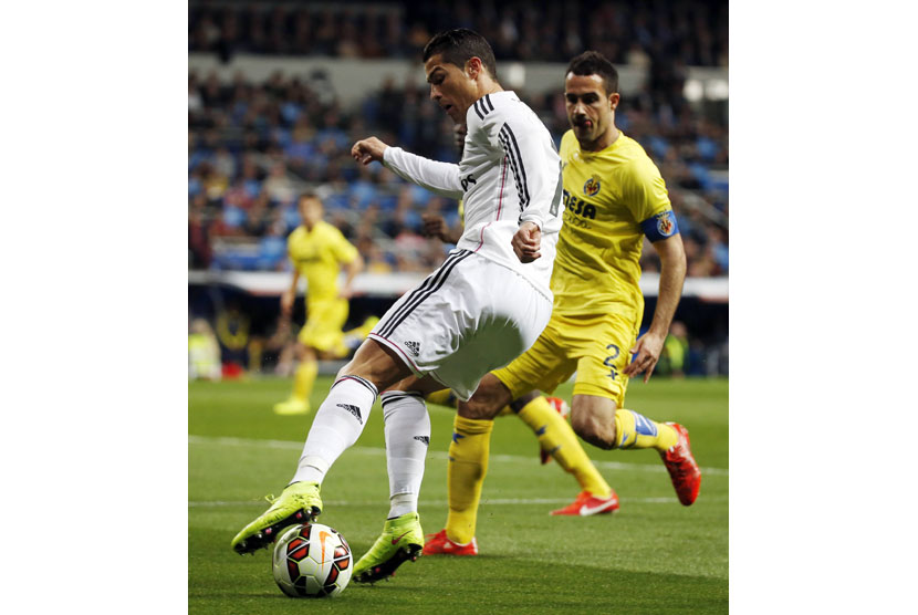 Real Madrid's Cristiano Ronaldo (L) controls the ball past Villarreal's Mario Gaspar Perez during their Spanish first division soccer match at Santiago Bernabeu stadium in Madrid, March 1, 2015. 