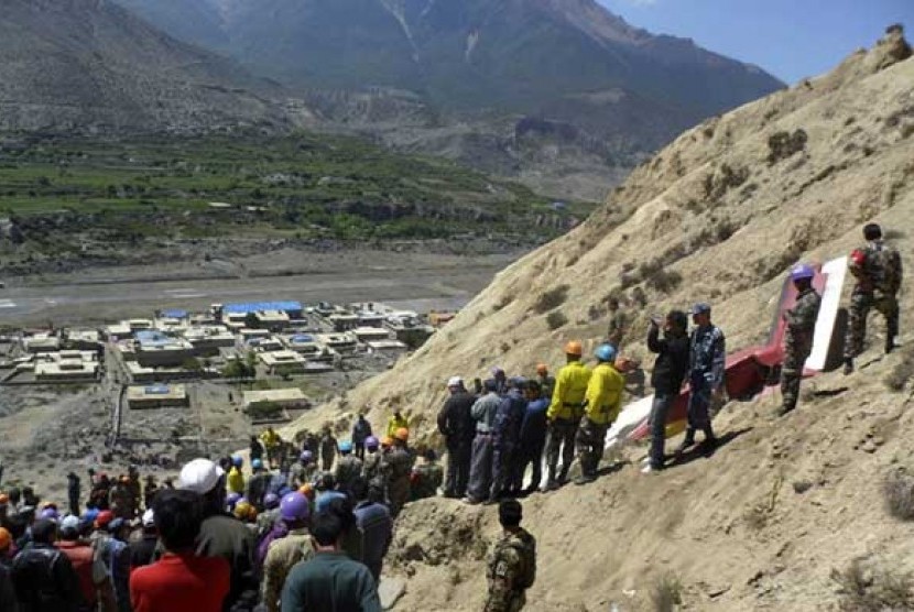      Regu penyelamat Nepal mengevakuasi korban kecelakaan pesawat di Gunung Himalaya, Nepal, Senin (14/5).