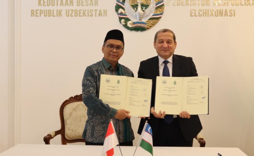   Rektor UIN Walisongo Semarang, Prof Imam Taufiq (kiri), dan Rektor International Islamic Academy of Uzbekistan, H E Mr Muzaffar Kamilov, menunjukkan dokumen perjanjian kerja sama yang telah mereka tanda tangani. 