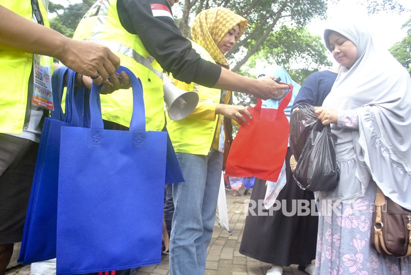 Relawan Konsorsium Peduli Bogor (KPB) membagikan tas guna ulang saat sosialisasi Bogor Anti Kantong Plastik (Antik) di Taman Ekspresi, Kota Bogor, Jawa Barat, Ahad (25/11). 