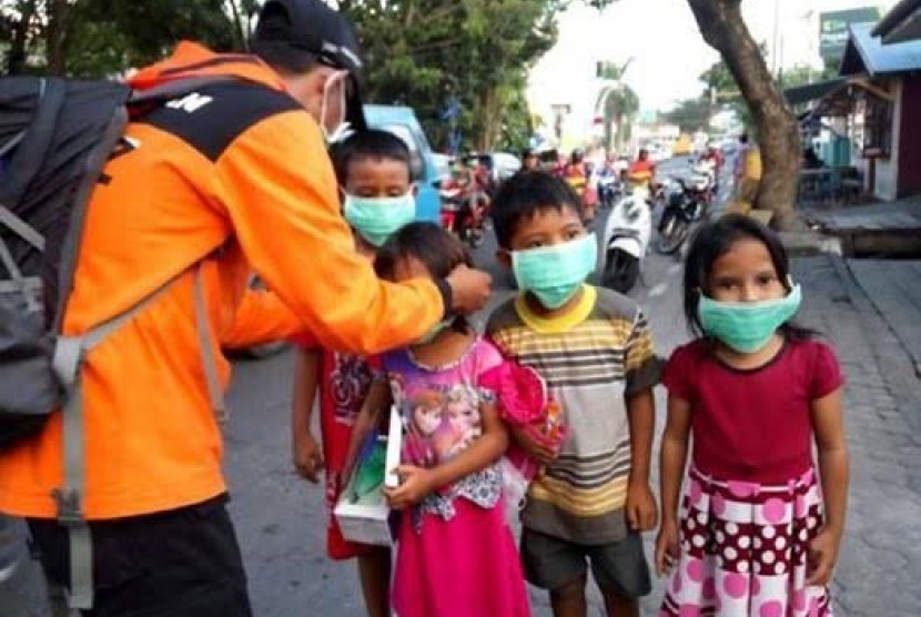 Relawan Rumah Zakat membagikan masker untuk korban erupsi Gunung Gamalama.