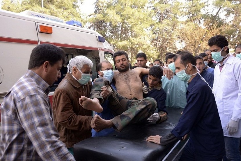 Residents and medics transport a Syrian Army soldier, wounded in what they said was a chemical weapon attack near Aleppo, to a hospital March 19, 2013. 