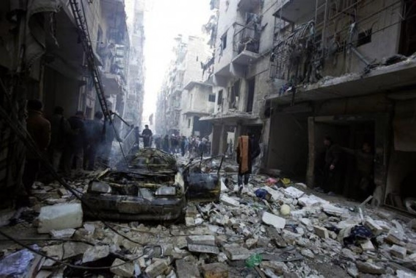 Para warga sipil melihat puing-puing reruntuhan di Aleppo, Suriah, usai serangan udara yang dilancarkan rezim Bashar Al Assad.