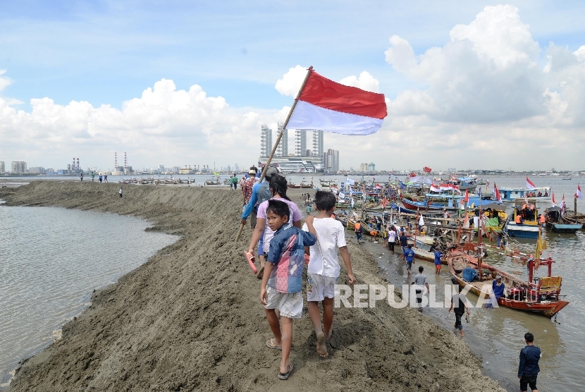 Ribuan nelayan bersama LSM melakukan aksi simbolis dengan menyegel pulau G proyek reklamasi di kawasan Muara Angke, Jakarta Utara, Ahad (17/4).