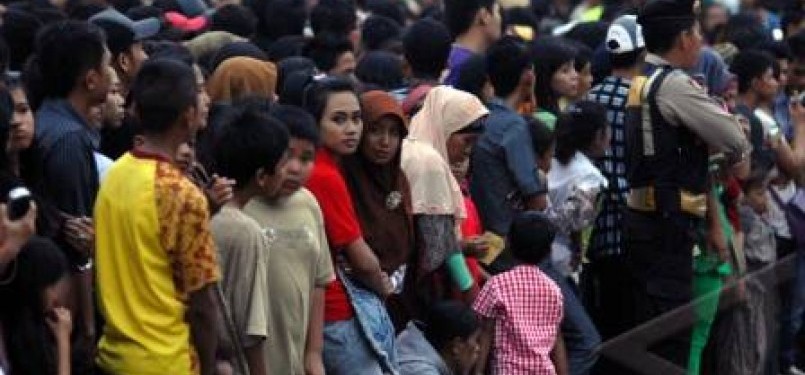 Ribuan warga memenuhi jalan di depan pintu masuk lokasi pembukaan SEA Games XXVI di kompleks Stadion Olahraga Sriwijaya Palembang Sumsel, Jumat (11/11). 