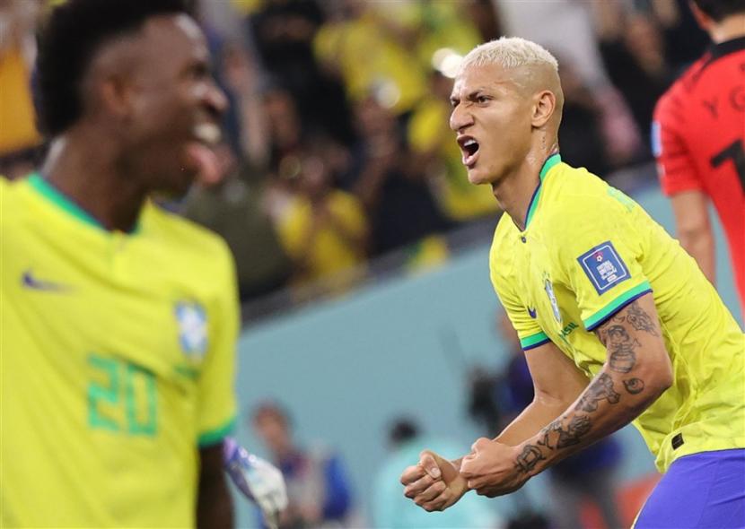  Richarlison dari Brasil merayakan skor 4-0 oleh Lucas Paqueta selama pertandingan sepak bola babak 16 besar Piala Dunia 2022 antara Brasil dan Korea Selatan di Stadium 974 di Doha, Qatar, Selasa (6/12/2022) dini hari WIB. 
