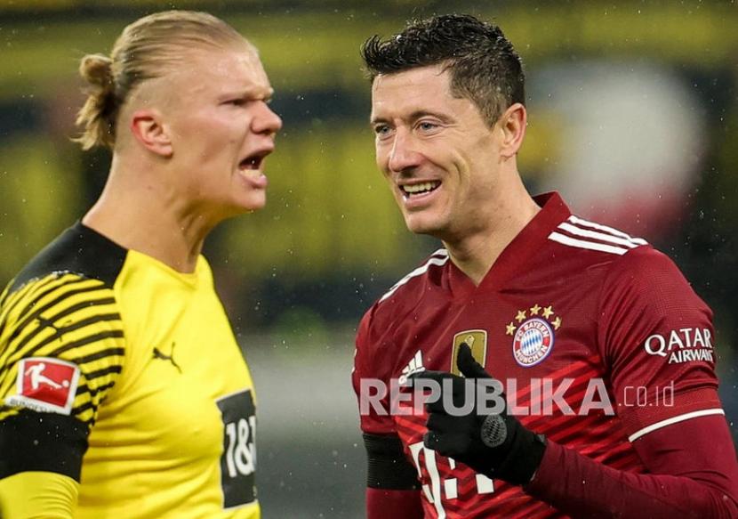Striker Bayern Muenchen Robert Lewandowski (kanan) dan striker Borussia Dortmund Erling Haaland diprediksi menjadi rebutan klub-klub elite Eropa musim depan..