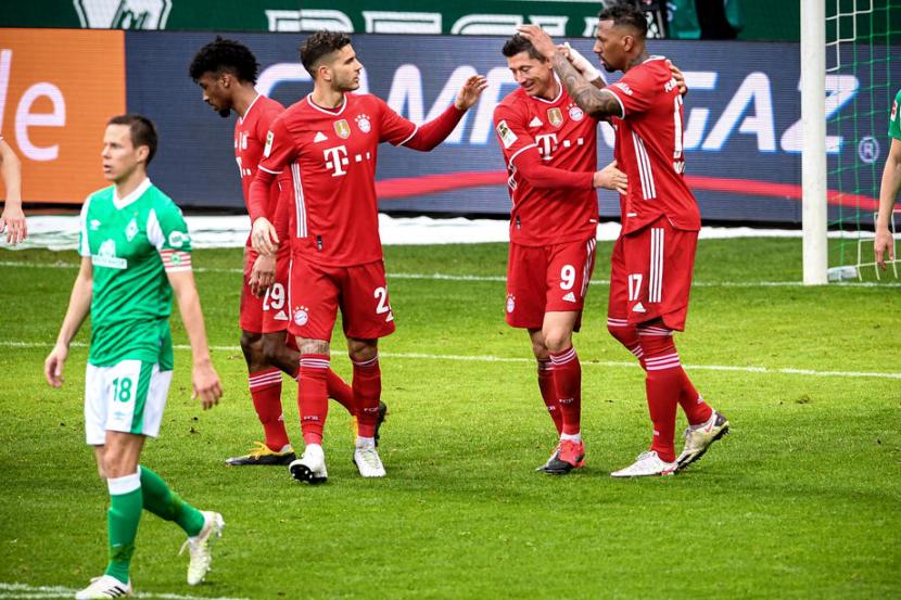 Robert Lewandowski (Tengah) diapit rekan-rekannya usai mencetak satu gol saat Bayern Muenchen kalahkah Werder Bremen 3-1 di Stadion Weser, Sabtu (13/3).