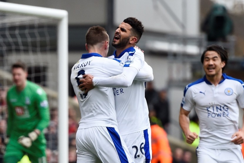 Ryad Mahrez (tengah) memeluk Jamie Vardy usai mencetak gol kemenangan Leicester City.