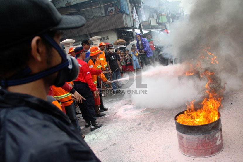  Satgas Kebakaran tengah berlatih menangani kebakaran di halaman Kelurahan Pekojan, Tambora, Jakarta Barat, Ahad (22/12).  (Republika/Yasin Habibi)