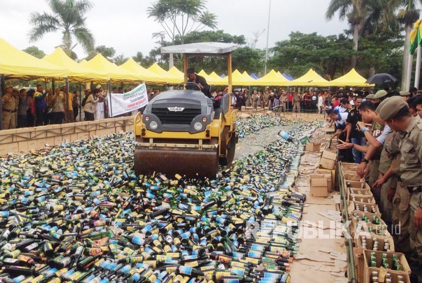 Petugas Satpol PP memusnahkan 21.460 botol miras di halaman kantor Pemerintah Kabupaten Bandung, Jumat (10/2). Miras yang dimusnahkan tersebut merupakan hasil penyitaan selama November 2016-Januari 2017.