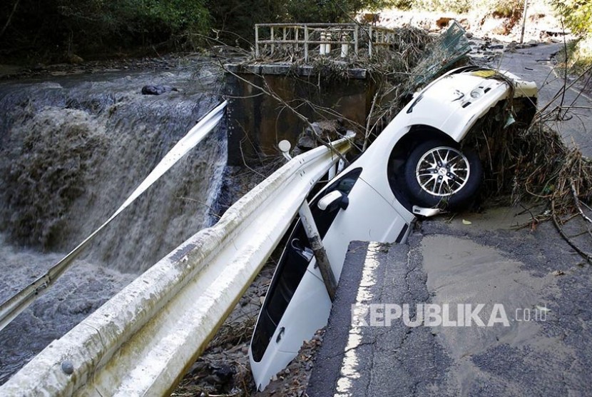 Sebuah mobil terseret air bah  di Prefektur Miyagi , Jepang, setelah Topan  Hagibis menghantam kota tersebut , Ahad (13/10).. 