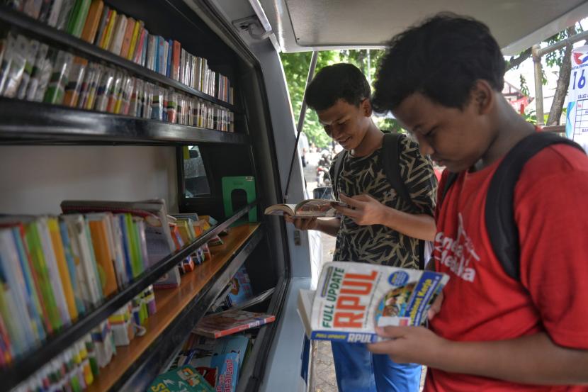 Sejumlah anak membaca buku di mobil perpustakaan keliling di Kawasan Jalan Bonang, Menteng, Jakarta.