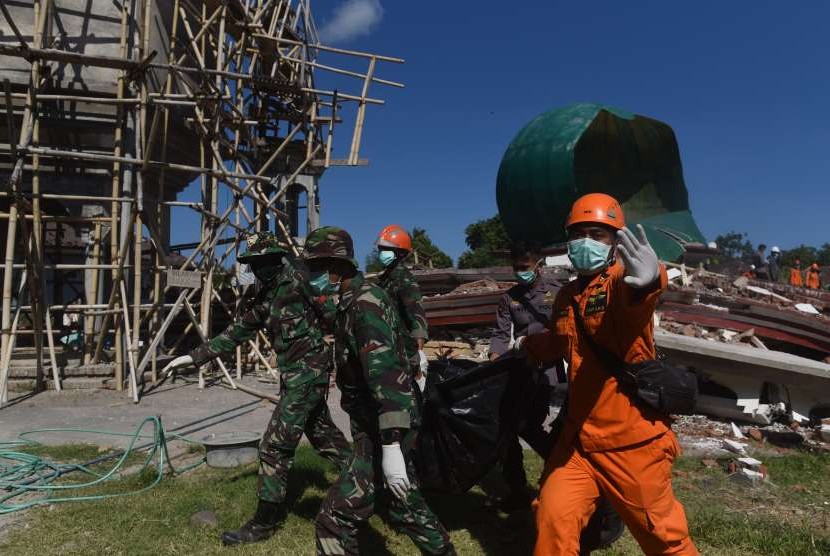 Sejumlah anggota Basarnas mengevakuasi jenazah korban yang meninggal akibat tertimbun reruntuhan Masjid Jabal Nur yang rusak akibat gempa bumi di Tanjung, Lombok Utara, NTB, Selasa (7/8).