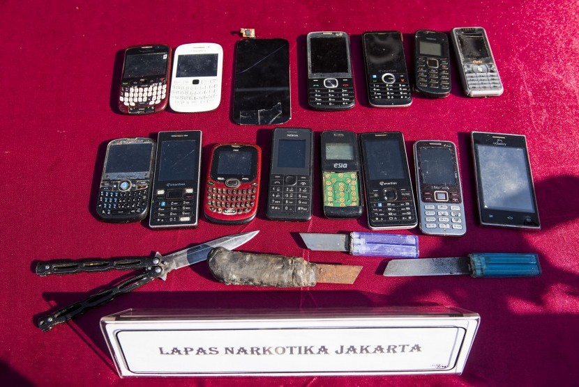 Sejumlah barang sitaan handphone dan senjata tajam dipamerkan sebelum pemusnahan hasil razia di lembaga pemasyarakatan di Lapas Narkotika Kelas II A Cipinang, Jakarta, Rabu (23/12).