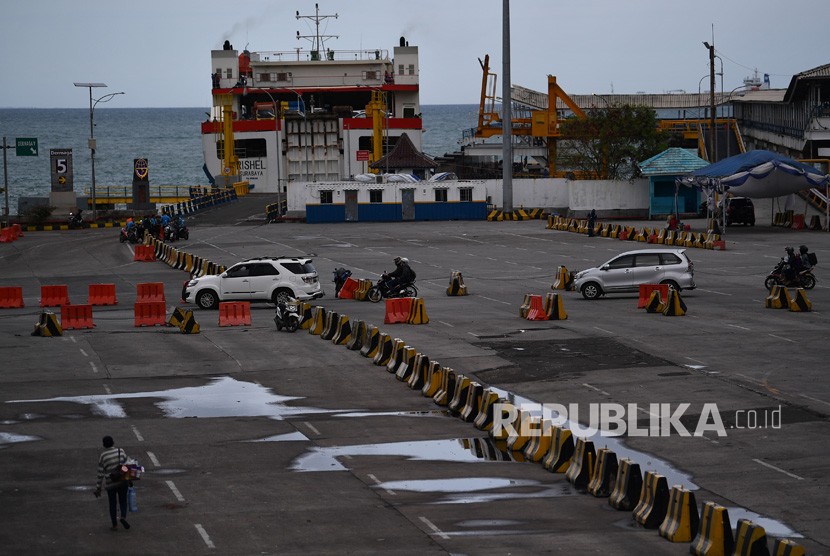 Sejumlah calon penumpang berkendaraan motor melintas menuju kapal untuk menyeberangi Selat Sunda di Pelabuhan Merak, Banten, Senin (31/12/2018). 