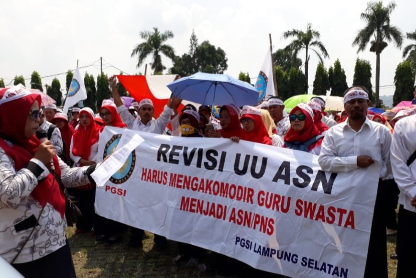 Sejumlah guru honor sekolah swasta tergabung dalam Persatuan Guru Selolah Indonesia Lampung menggelar aksi damai di depan gedung DPRD Lampung, Senin (30/4).