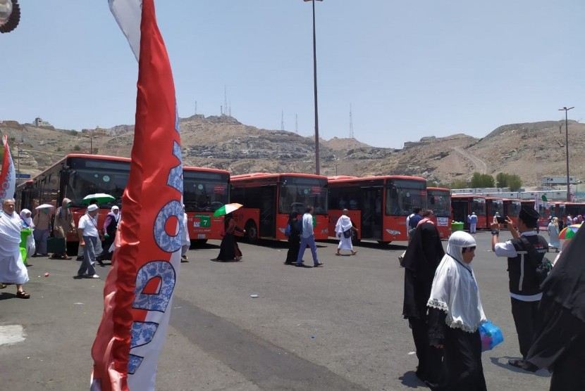 Sejumlah jamaah melintas di depan bus shalawat yang melayani rute dari pemondokan ke Masjidil Haram, Makkah, Senin (5/8). Terminal Syib Amir melayani enam rute, antara lain Syisyah  Rawda, dan Jarwal. 