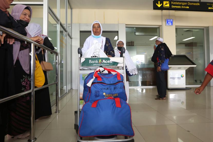 Sejumlah jamaah umroh dari Aceh tiba kembali di tanah air melalui Bandara Internasional Sultan Iskandar Muda, Aceh Besar, Aceh, Rabu (16/3/2022). Data Kementerian Agama menyebutkan sebanyak 27 ribu lebih orang dari 41 ribu lebih ja­maah umrah dari berbagai daerah di Indonesia telah kembali ke tanah air hingga pertengahan Maret 2022. Musim Umroh Bagi Jamaah Internasional Berakhir 31 Mei