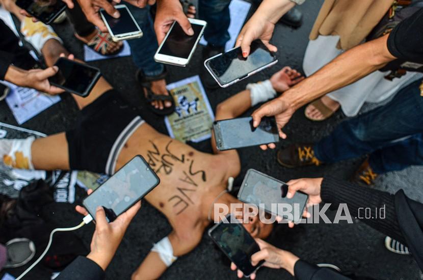 Sejumlah jurnalis yang tergabung dalam Forum Jurnalis Tasik Melawan melakukan teatrikal saat aksi solidaritas di Tugu Asmaul Khusna, Kota Tasikmalaya, Jawa Barat, Kamis (1/4/2021). Mereka menuntut kepada Kapolri untuk menuntaskan kasus kekerasan dan penganiayaan yang diduga dilakukan oleh oknum aparat terhadap Jurnalis Tempo yang sedang melaksanakan tugas jurnalistiknya, di Surabaya, bahkan Lembaga Bantuan Hukum (LBH) Pers dan Aliansi Jurnalis Independen (AJI) Indonesia mencatat, kasus kekerasan terhadap wartawan dan media pada tahun 2020 meningkat sebanyak 117 kasus dibandingkan pada 2019 sebanyak 79 kasus.