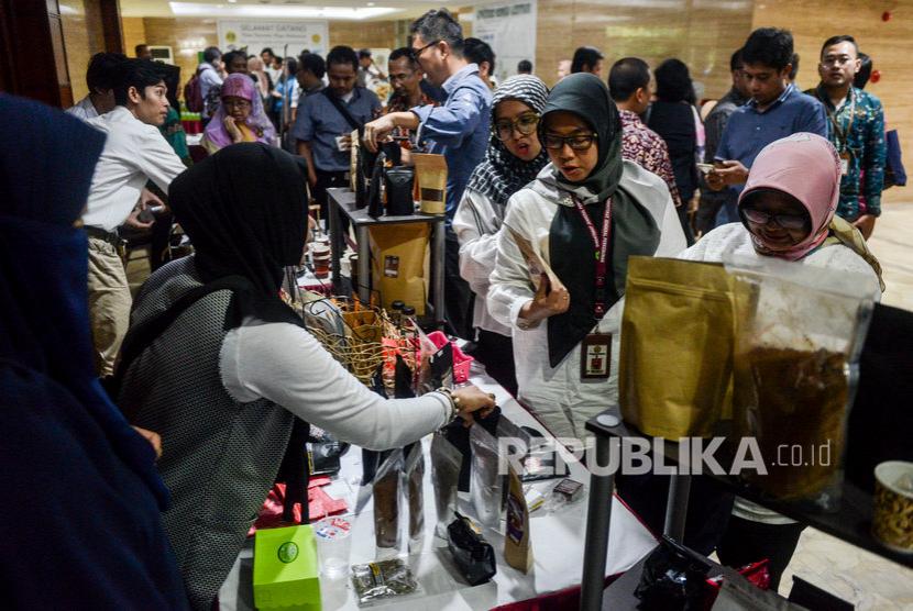 Sejumlah karyawan Kementerian Pertanian melihat produk kopi yang dijual saat peringatan Hari Kopi Nasional 2020 di kantor Kementerian Pertanian, Ragunan, Jakarta, Rabu (11/3). BSN mengajak pelaku usaha mikro untuk mendapatkan SNI bagi produk kopinya.