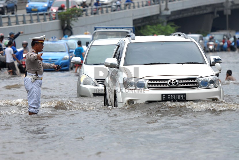 Sejumlah kendaraan melintasi banjir yang merendam ruas Jalan S. Parman di depan Universitas Trisakti, Grogol, Jakarta Barat, Sabtu (18/1). (Republika/Rakhmawaty La'lang)