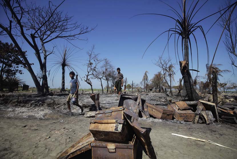  Sejumlah orang mengumpulkan potongan logam dari puing perkampungan Pauktaw yang dibakar dalam kekerasan baru-baru ini di Rakhine,Myanmar, Sabtu (27/10). (Soe Zeya Tun/Reuters)  
