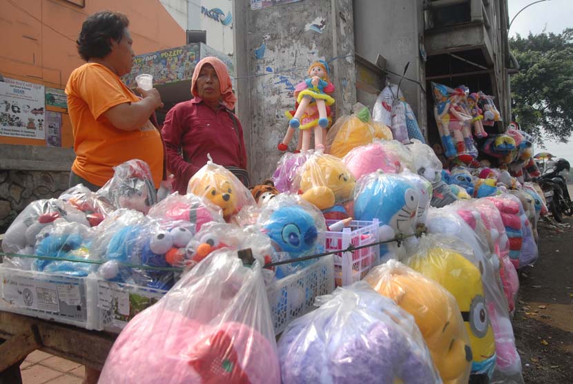 Sejumlah Pedagang Kaki Lima (PKL) menjajakkan boneka dagangannya di bawah kolong jembatan penyeberangan orang (JPO) depan Pasar Cipinang Besar, Senin (12/5).