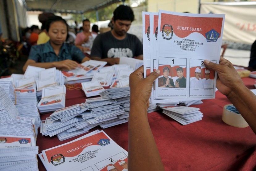 Sejumlah pekerja memeriksa surat suara untuk pemilihan kepala daerah (Pilkada) di Komisi Pemilihan Umum (KPU) Kabupaten Badung, Bali, Selasa (17/11). 