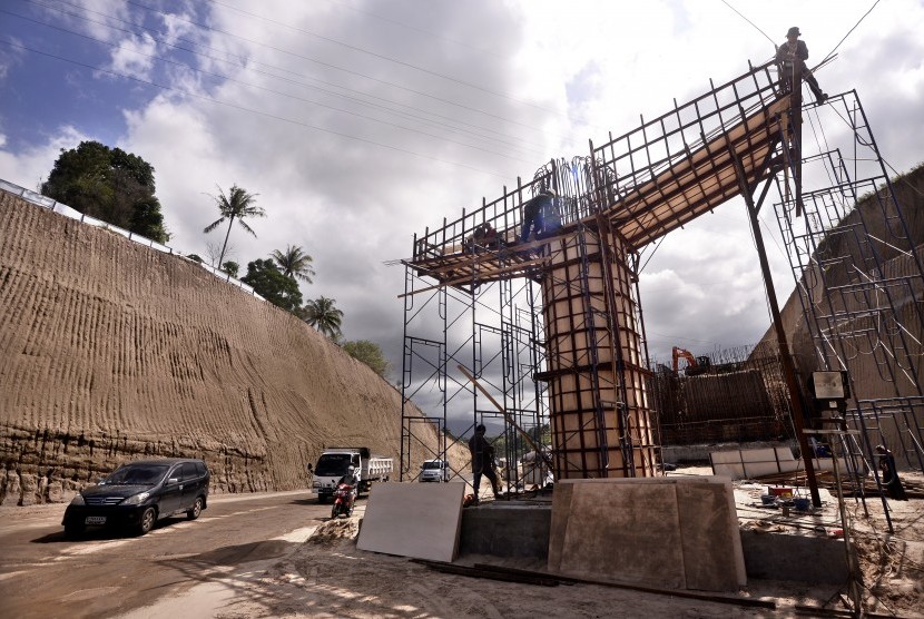 Sejumlah pekerja menyelesaikan proyek pembangunan jalan tol Manado-Bitung di Manado, Sulawesi Utara, Rabu (2/3).