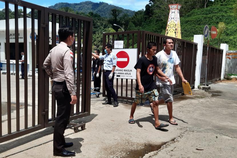 Sejumlah Pekerja Migran Indonesia (PMI) melintasi pintu pagar setibanya di Pos Lintas Batas Negara (PLBN) Entikong, Kabupaten Sanggau, Kalbar, Sabtu (21/3/2020).