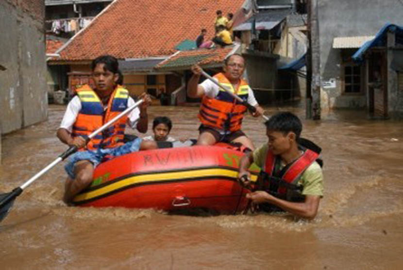 Sejumlah Pemuda dengan perahu karet bersiap-siap menolong warga yang terkena banjir. ilustrasi