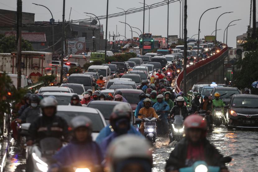 Sejumlah pengendara terjebak kemacetan di Jalan Arif Rahman Hakim, Depok, Jawa Barat, Rabu (19/10/2022). Hujan deras serta buruknya sistem drainase di kawasan tersebut menyebabkan jalan raya tergenang air setinggi 50cm dan berimbas kepada kemacetan panjang.