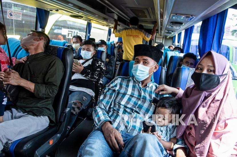 Sejumlah penumpang dengan mengenakan masker duduk di dalam bus di Terminal Kalideres, Jakarta Barat, Senin (26/4/2021). Meski adanya aturan larangan mudik mulai dari 22 April - 24 Mei 2021, armada perusahaan otobus (PO) tetap beroperasi di Terminal Kalideres. 
