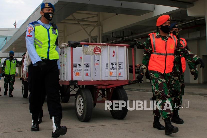Sejumlah personel TNI AU Lanud El Tari Kupang mengawal kedatangan tujuh koli vaksin COVID-19 Sinovac di Bandara El Tari Kupang, Kota Kupang, NTT Selasa (5/1/2021). Sebanyak 13.200 dosis vaksin COVID-19 Sinovac tahap pertama tiba di NTT yang diperuntukan bagi 6.600 tenaga kesehatan di provinsi itu. 