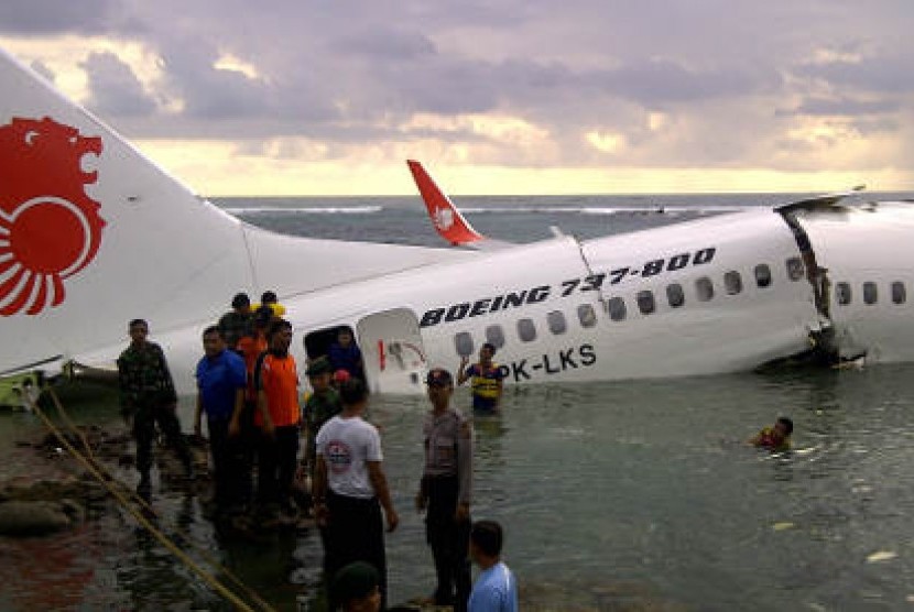Sejumlah petugas gabungan melakukan evakuasi barang dan penumpang pesawat Lion Air yang tergelincir ke laut setelah berusaha mendarat di Bandara Ngurah Rai Denpasar, Bali, Sabtu (13/4/2013)