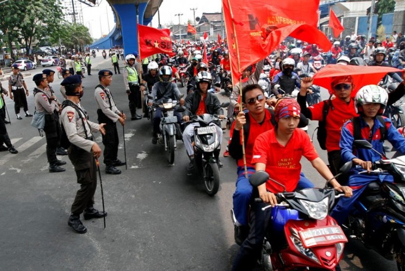 Sejumlah petugas keamanan menjaga berlangsungnya aksi Mogok Nasional Di sekitar Pintu Tol Cikarang Barat, Jawa Barat. Rabu (3/10). Untuk menghindari penutupan tol Jakarta-Cikampek dan aksi yang menjurus pada tindakan makar, sebanyak 2.331 petugas dikerahka