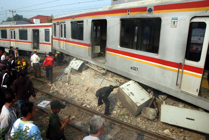  Sejumlah petugas melakukan pemeriksaan sebelum melakukan evakuasi gerbong KRL Commuter Line Jurusan Bogor-Jakarta Kota yang anjlok dan menabrak pembatas rel di Stasiun Cilebut, Bogor, Kamis (4/10).(Jafkhairi/Antara)