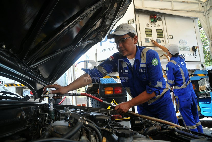 Sejumlah petugas mengisi bahan bakar gas ke kendaraan di Stasiun Pengisian BBG Monas, Jakarta, Rabu (17/9). ( Republika/Prayogi)