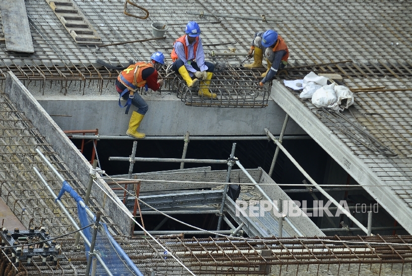 Sejumlah petugas menyelesaikan proyek pembangunan moda transportasi massal, Mass Rapid Transit (MRT) di Jalan Kyai Maja, Jakarta Selatan, Ahad (9/7). 